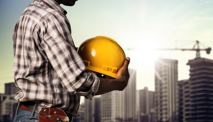 engineer-architect-with-yellow-safety-helmet-construction-site-background_795422-6915
