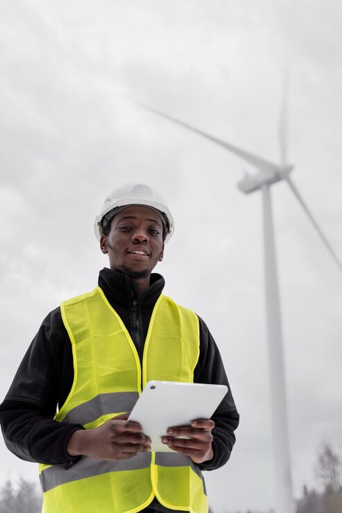 medium-shot-smiley-engineer-holding-tablet_23-2149353969
